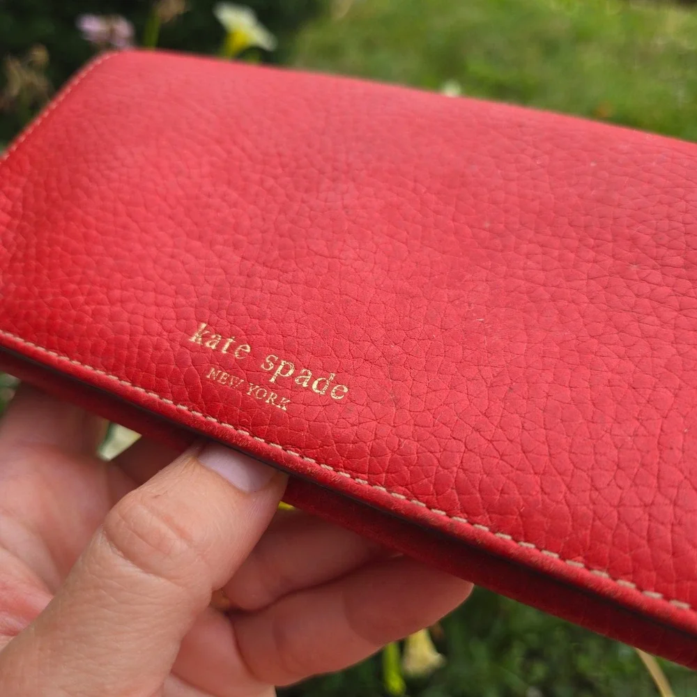 kate spade bifold pebble leather wallet. In red. Flaws